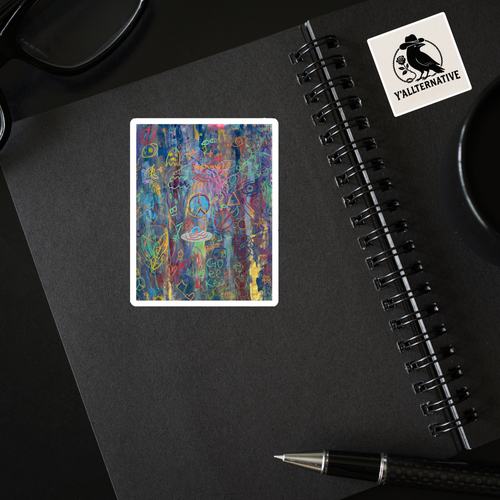 Colorful graffiti abstract sticker on a black notebook with a pen and glasses in the background