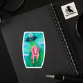 A pink pig sticker on a notebook beside a pen, showcasing a playful and creative stationery arrangement.
