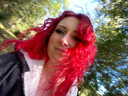 Picture of the Artist - Person with red hair looking up at trees