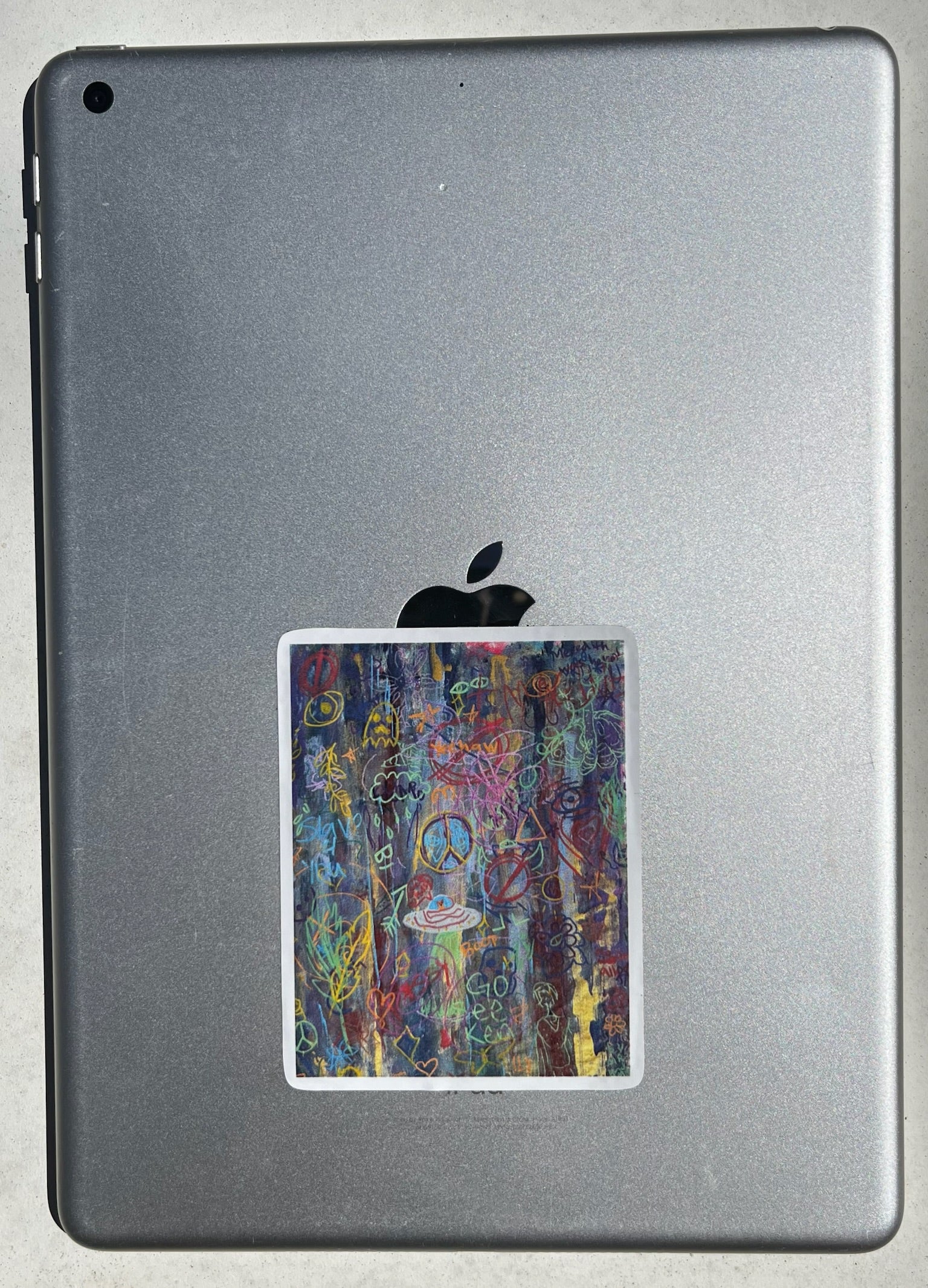 Back view of a tablet with a colorful graffitti sticker